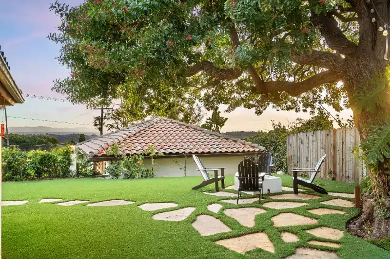 a nice backyard with chairs and good stonework