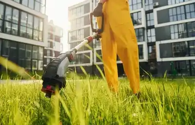 man cutting grass outdoors