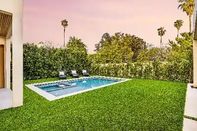 modern backyard with a pool and lounge chairs