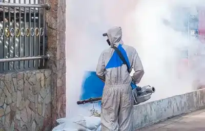 worker spraying chemicals